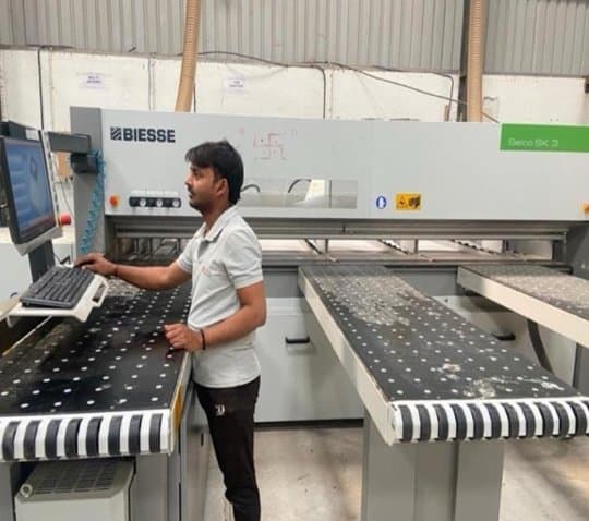 Operator running the Biesse Selco SK3 beam saw at the CMA Modular unit